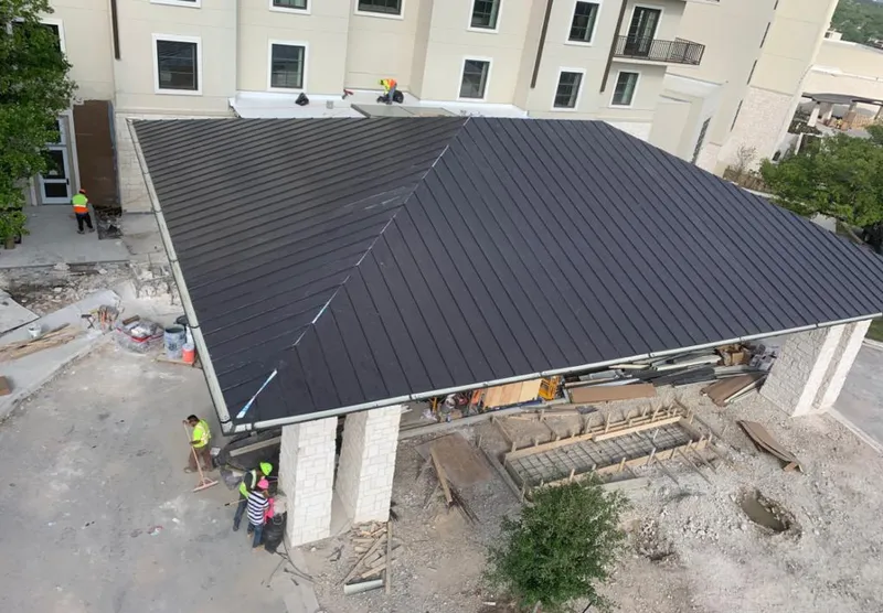 Metal roofing installation team working on a commercial building in Barnhart